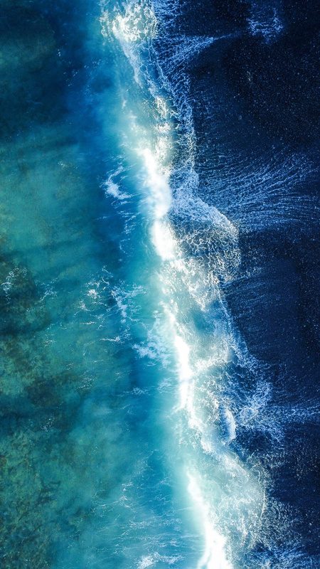 Aerial view of waves meeting the shore